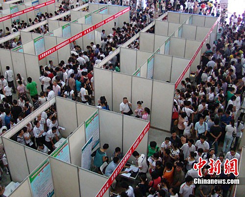 圖為招聘會現(xiàn)場人山人海的求職者。中新社發(fā) 付美斌 攝