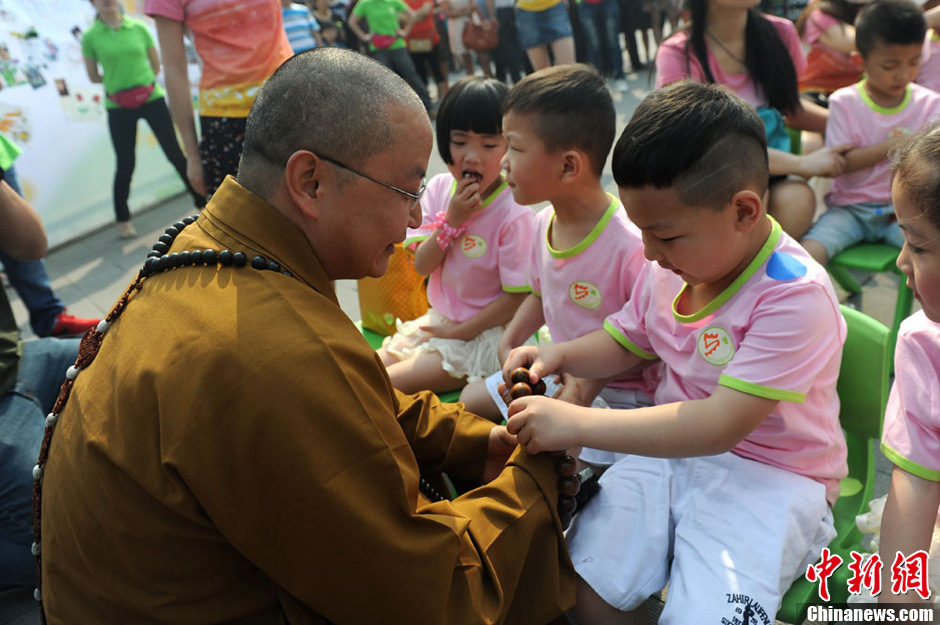 圖為羅漢寺素全法師與參加生日party的孩子。張浪 攝