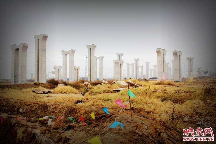 由于項目已經(jīng)停工數(shù)月，施工工地上很難見到工人，設(shè)備也很少，雜草叢生，顯得非?；臎觥? width=