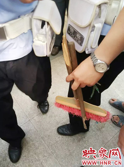 老太從環(huán)衛(wèi)工手中奪過掃帚，用腳踩斷，用力向環(huán)衛(wèi)工人的手上和腿上敲去。