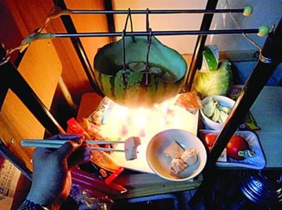 兩張椅子被面對(duì)面疊在一起，穿了兩根線的西瓜皮就懸空在椅腳中間，下面有蠟燭加熱，這就是西瓜火鍋。